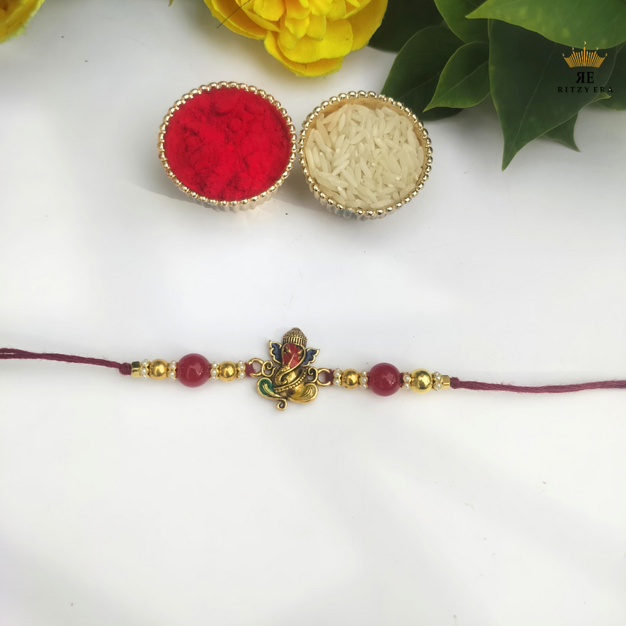Divine Ganesha Rakhi – Red & Gold Beads